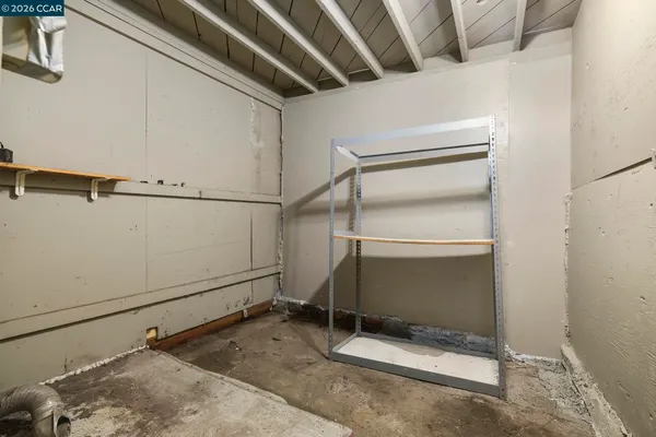 a view of a backyard with wooden fence and a large tree