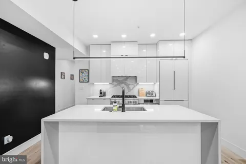 a kitchen with a sink a stove and refrigerator