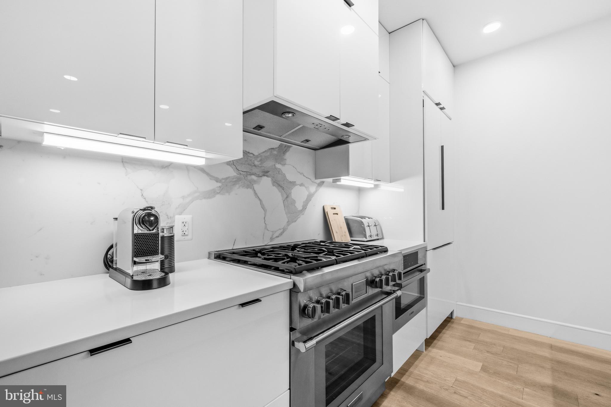 1729 T Street Northwest, Unit 3 Washington, DC 20009 - Photo 12 of 38 a kitchen with a stove and wooden floor