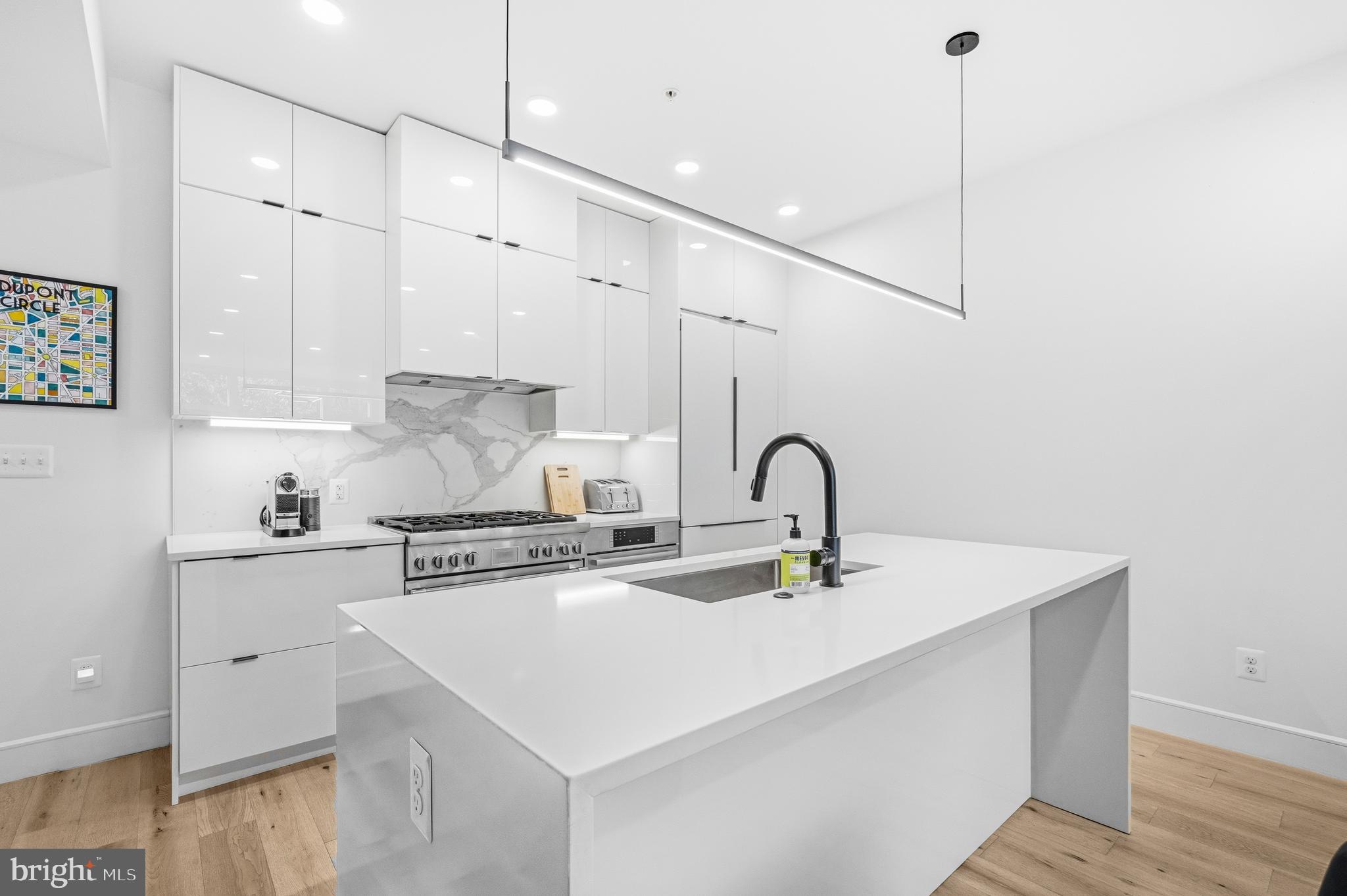 1729 T Street Northwest, Unit 3 Washington, DC 20009 - Photo 15 of 38 a kitchen with stainless steel appliances a sink a stove a refrigerator and cabinets