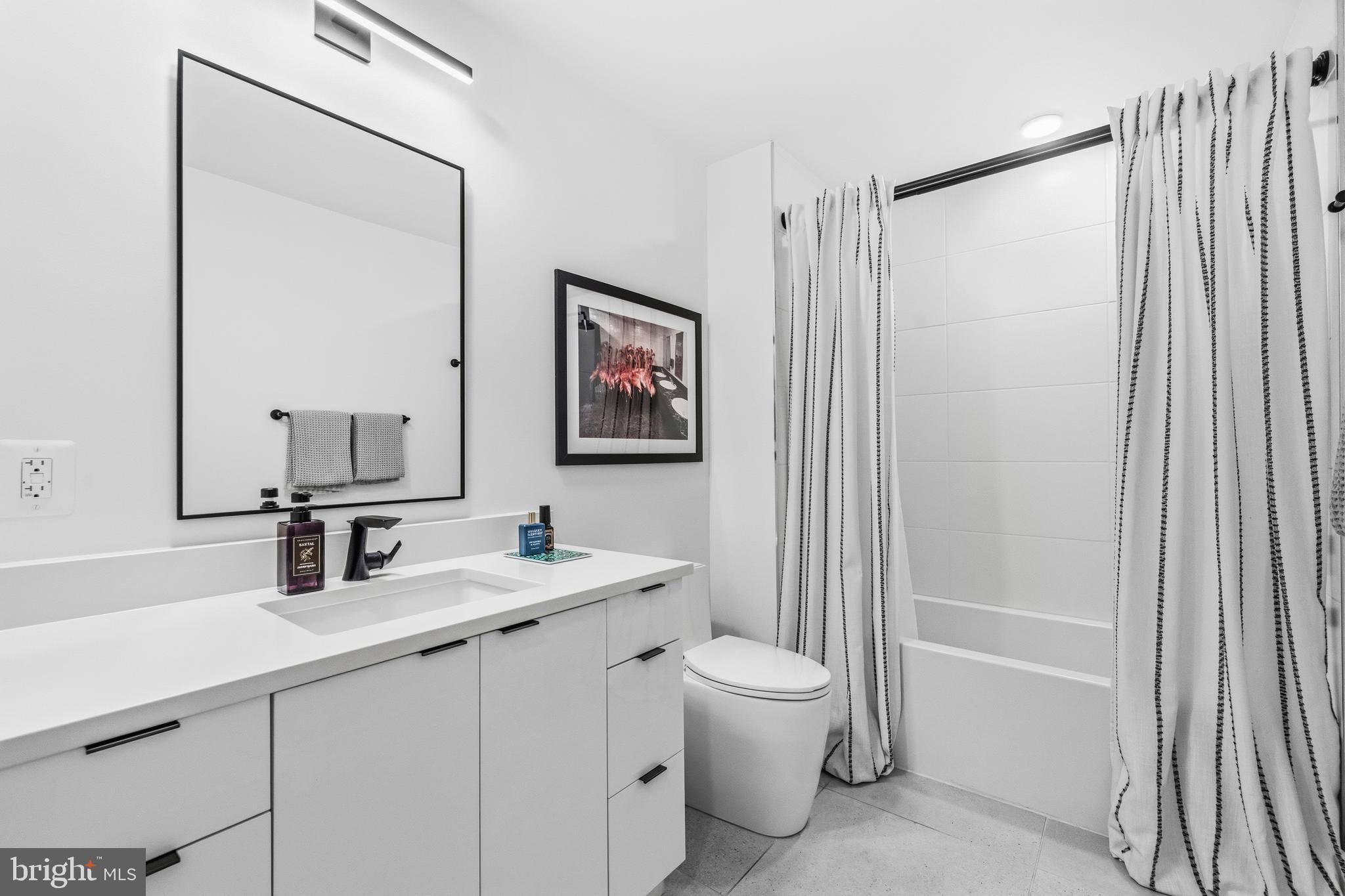 1729 T Street Northwest, Unit 3 Washington, DC 20009 - Photo 27 of 38 a bathroom with a double vanity sink toilet and shower
