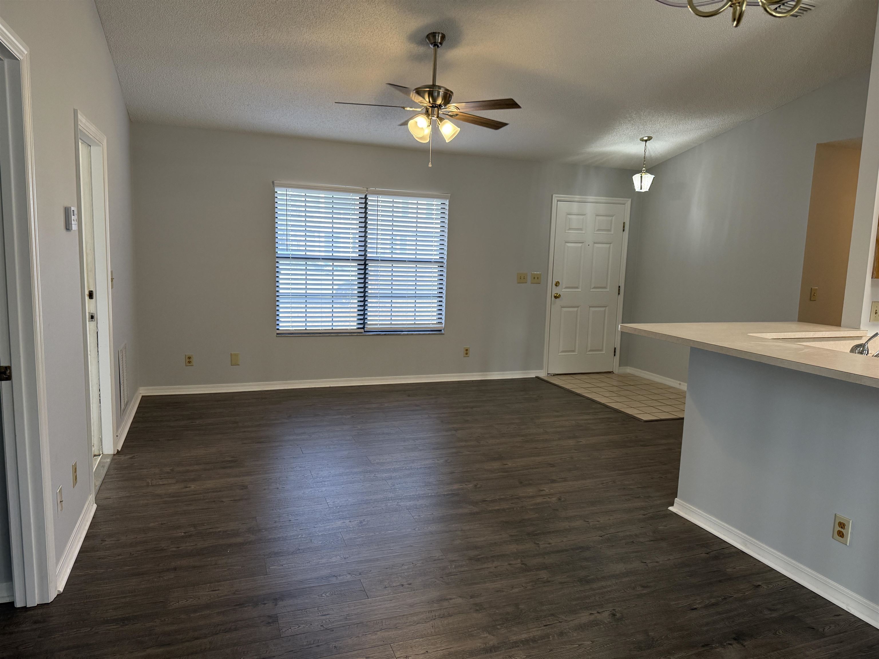 997 Irma Way St. Augustine, FL 32086 - Photo 3 of 10 an empty room with wooden floor and windows