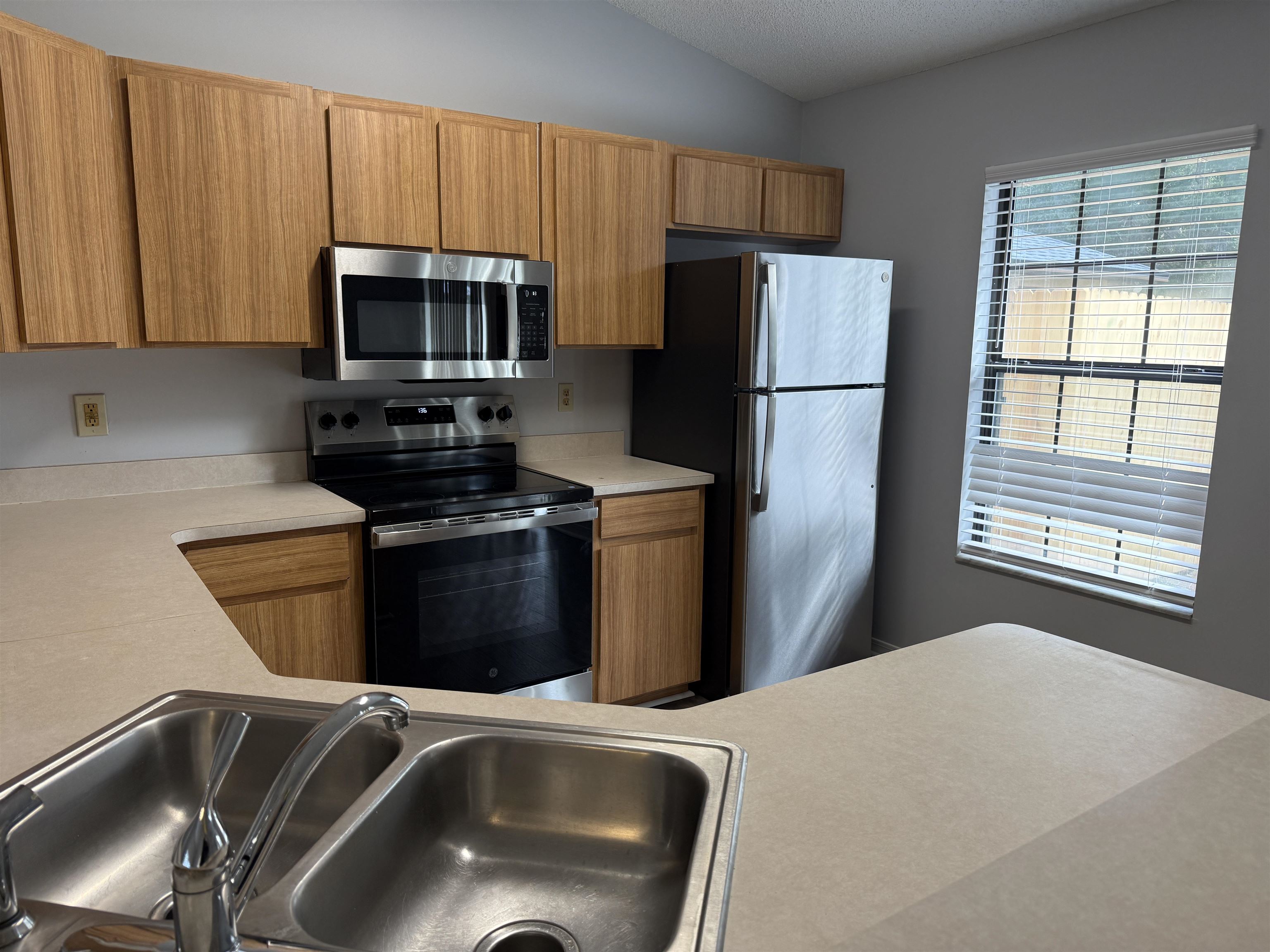 997 Irma Way St. Augustine, FL 32086 - Photo 4 of 10 a kitchen with stainless steel appliances granite countertop a refrigerator a stove a sink dishwasher and microwave