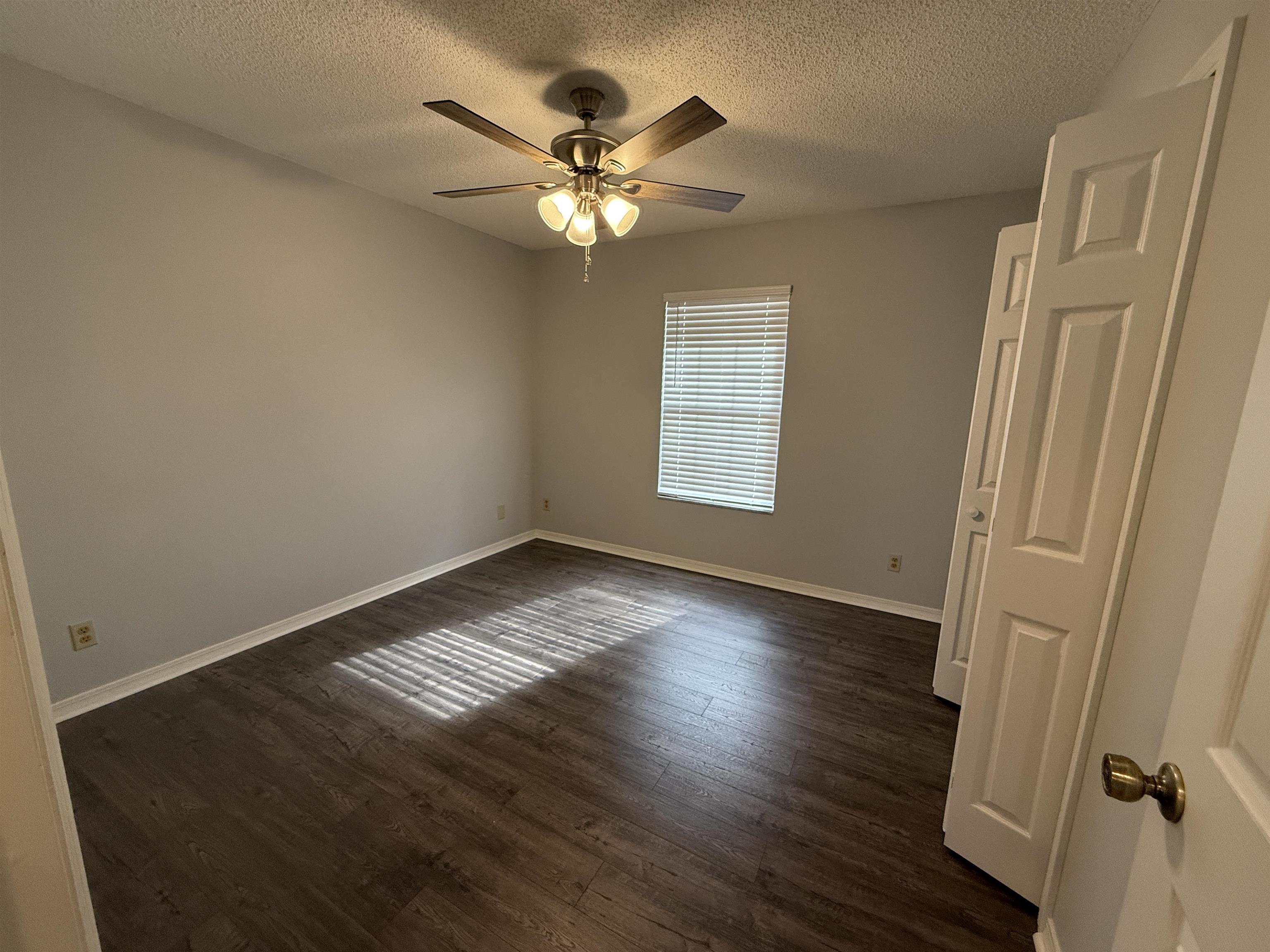 997 Irma Way St. Augustine, FL 32086 - Photo 6 of 10 a view of an empty room with wooden floor and a window