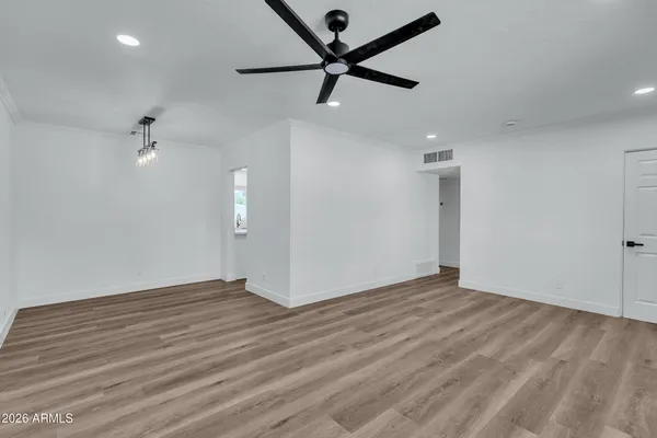 a view of a hallway with wooden floor and staircase
