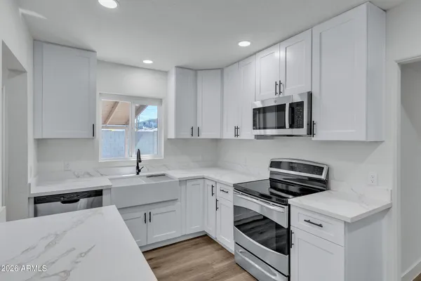 a kitchen with a sink cabinets and stainless steel appliances