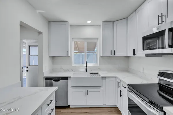 a kitchen with a refrigerator stove and microwave