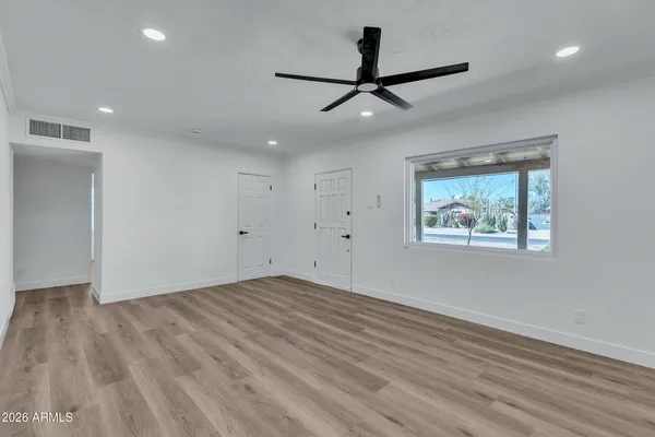 wooden floor in an empty room with a window