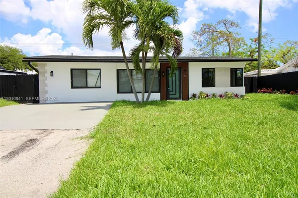a open kitchen with stainless steel appliances kitchen island granite countertop a refrigerator and a sink