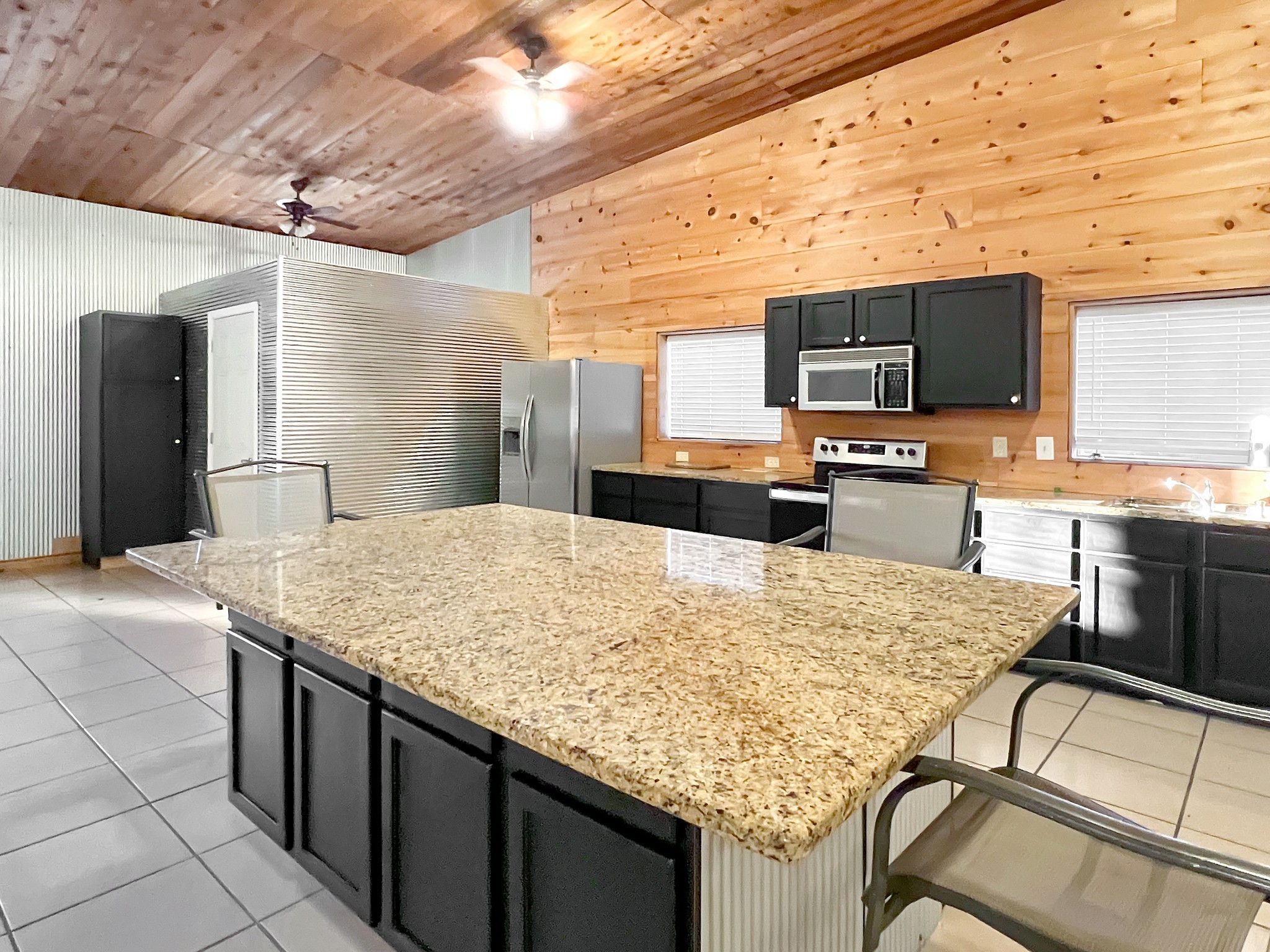 2982 Harvey Bowden Road Springville, TN 38256 - Photo 38 of 48 a kitchen with stainless steel appliances kitchen island granite countertop a kitchen island a stove and a refrigerator