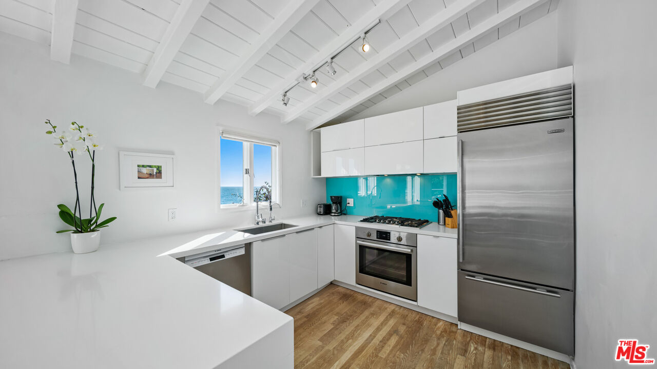 21344 Rambla Vista Malibu, CA 90265 - Photo 11 of 32 a kitchen with a refrigerator sink and stainless steel appliances