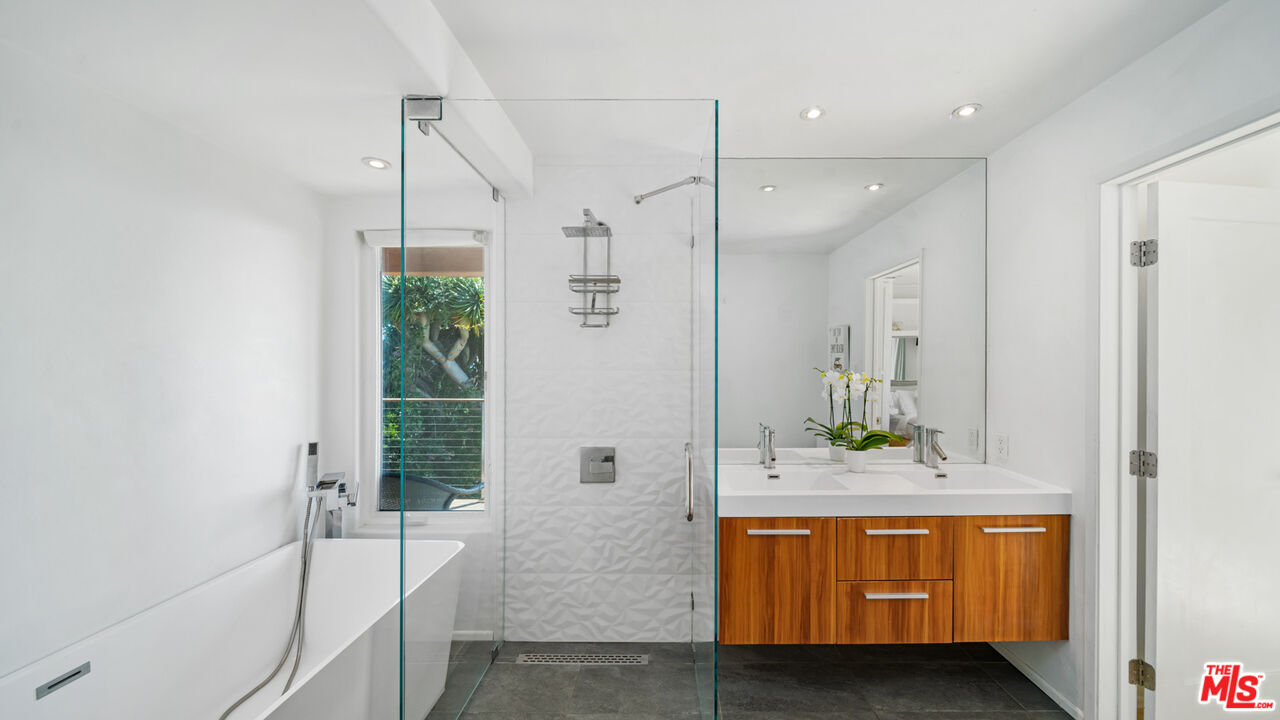21344 Rambla Vista Malibu, CA 90265 - Photo 15 of 32 a bathroom with a tub sink and mirror