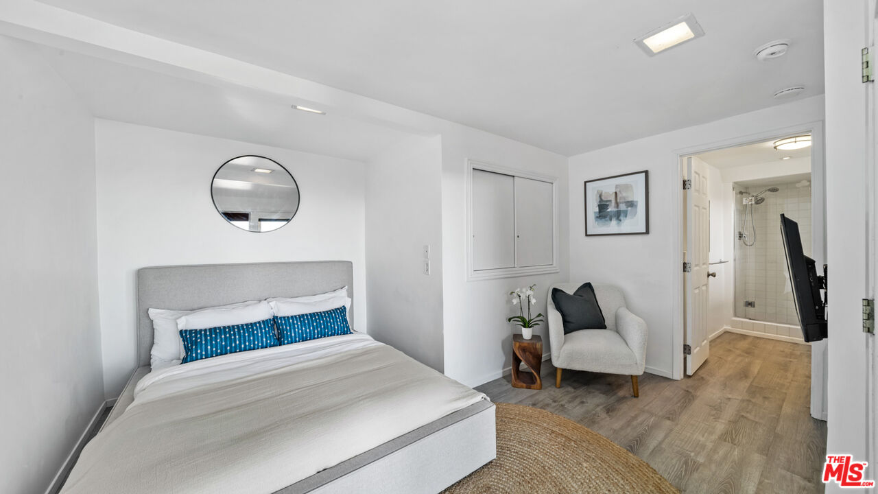 21344 Rambla Vista Malibu, CA 90265 - Photo 17 of 32 a bedroom with a bed and painting on the wall