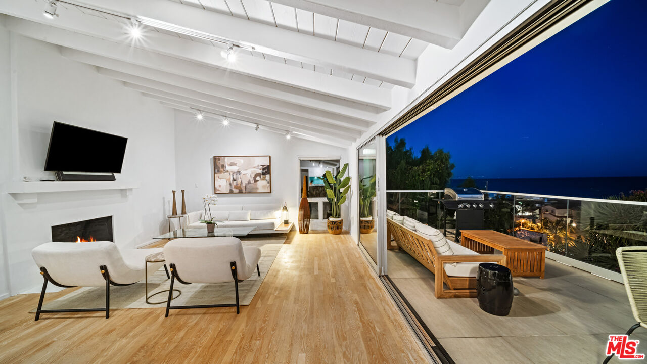 21344 Rambla Vista Malibu, CA 90265 - Photo 20 of 32 a living room with fireplace furniture and a flat screen tv
