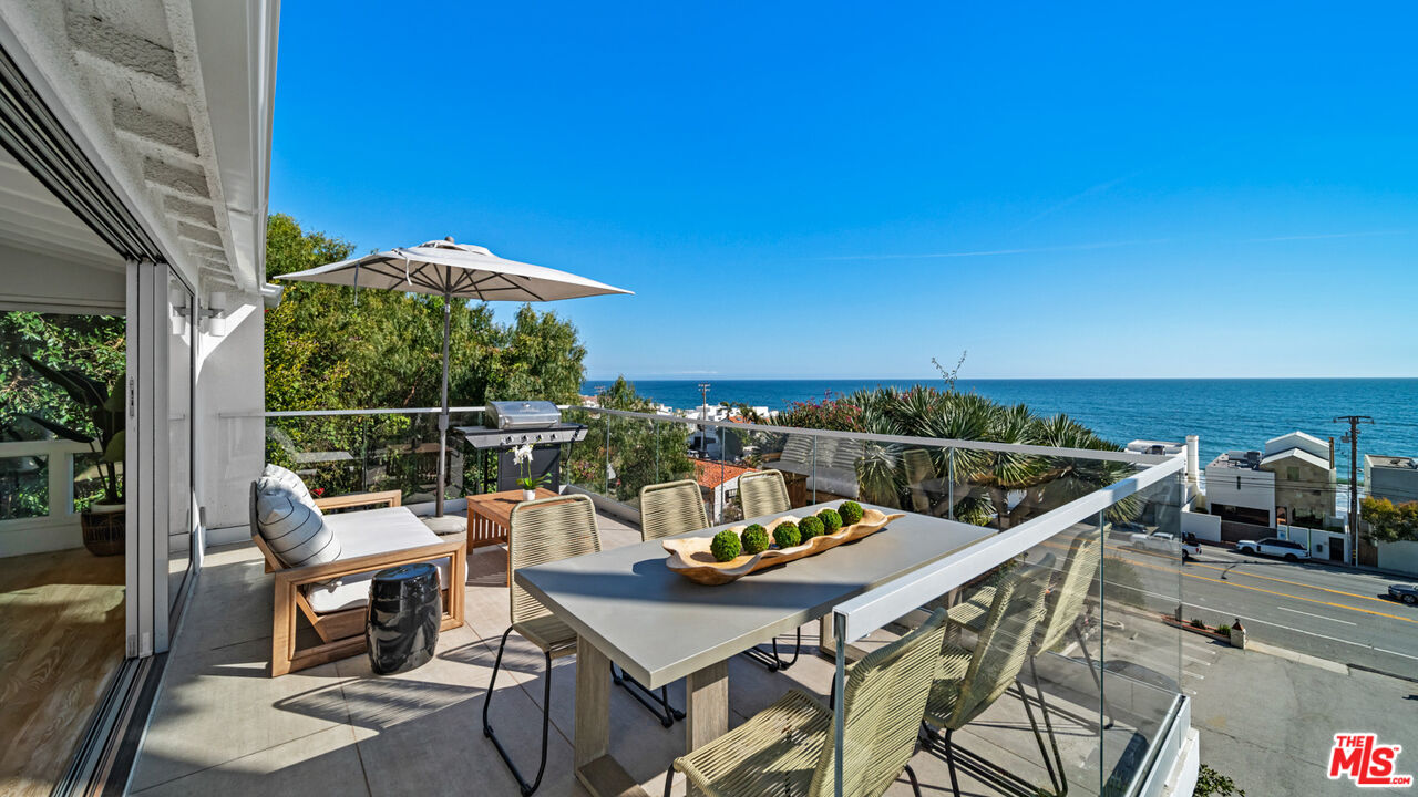 21344 Rambla Vista Malibu, CA 90265 - Photo 2 of 32 a view of a balcony with two chairs and a table
