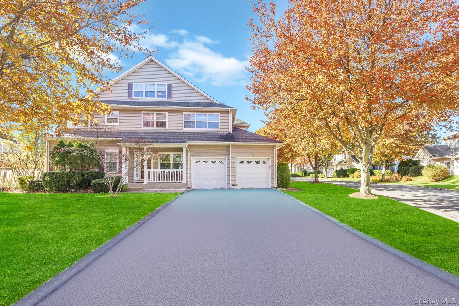 a view of a big house with a big yard and large trees
