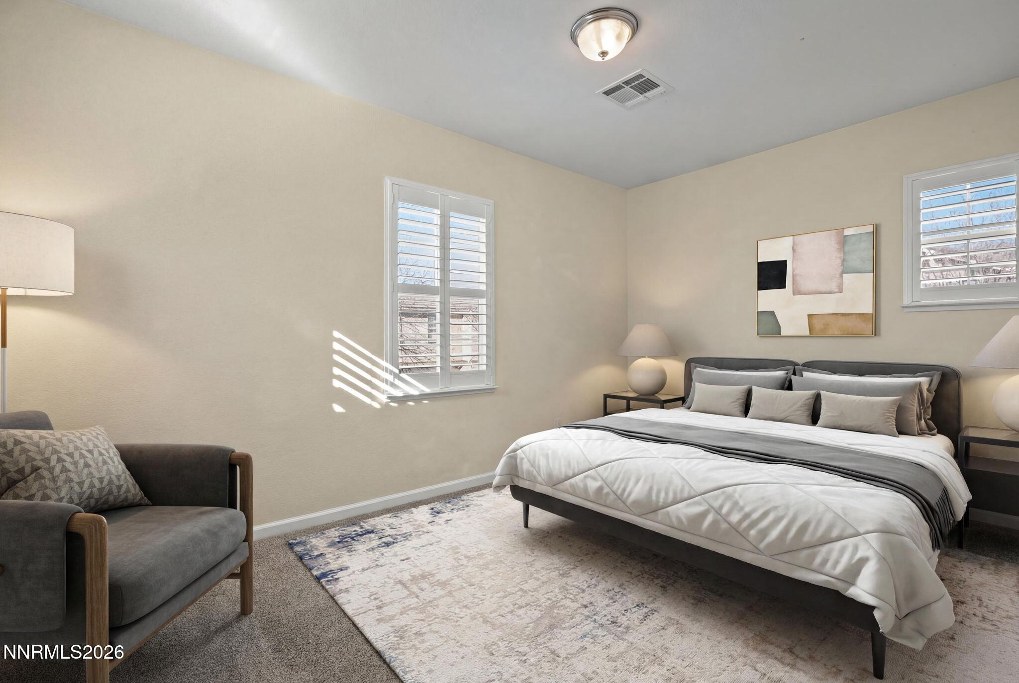 6953 Sacred Circle Sparks, NV 89436 - Photo 15 of 26 a bedroom with a bed and a couch