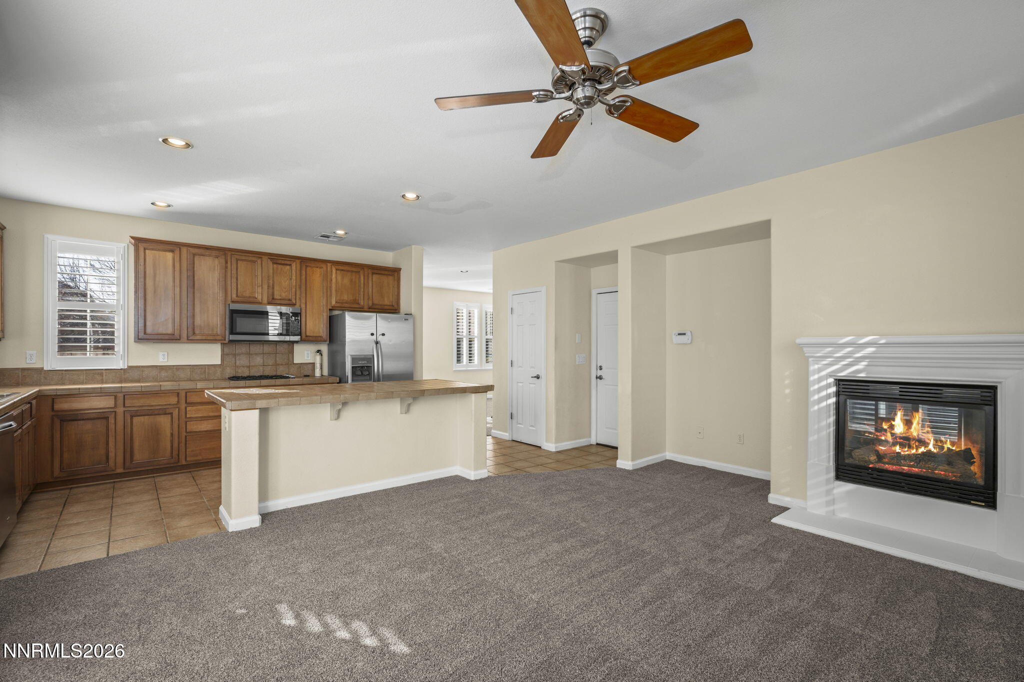 6953 Sacred Circle Sparks, NV 89436 - Photo 19 of 26 a open kitchen with white cabinets and white appliances