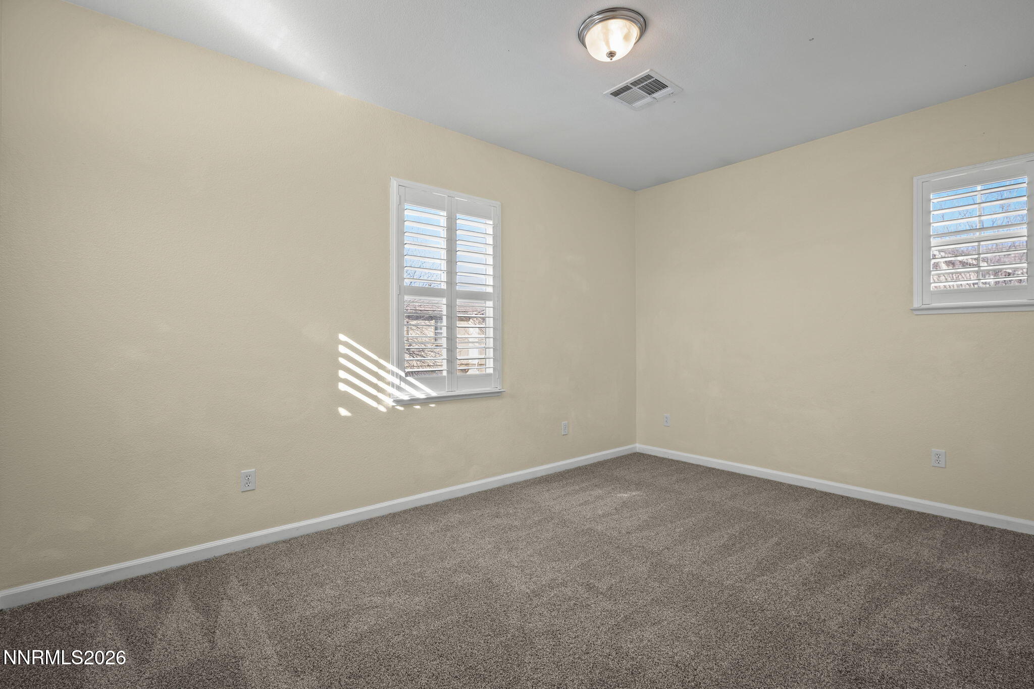 6953 Sacred Circle Sparks, NV 89436 - Photo 23 of 26 an empty room with windows