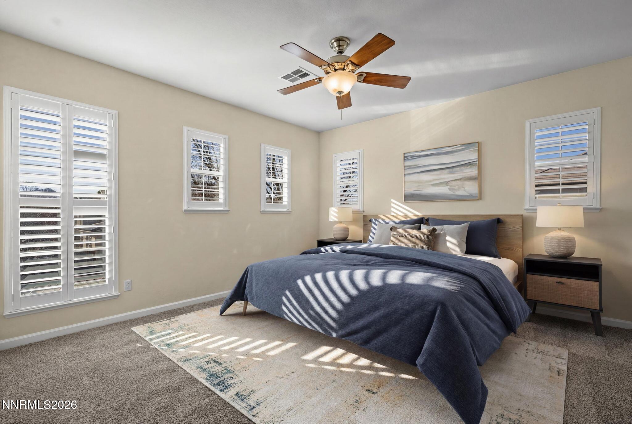 6953 Sacred Circle Sparks, NV 89436 - Photo 10 of 26 a spacious bedroom with a bed and window