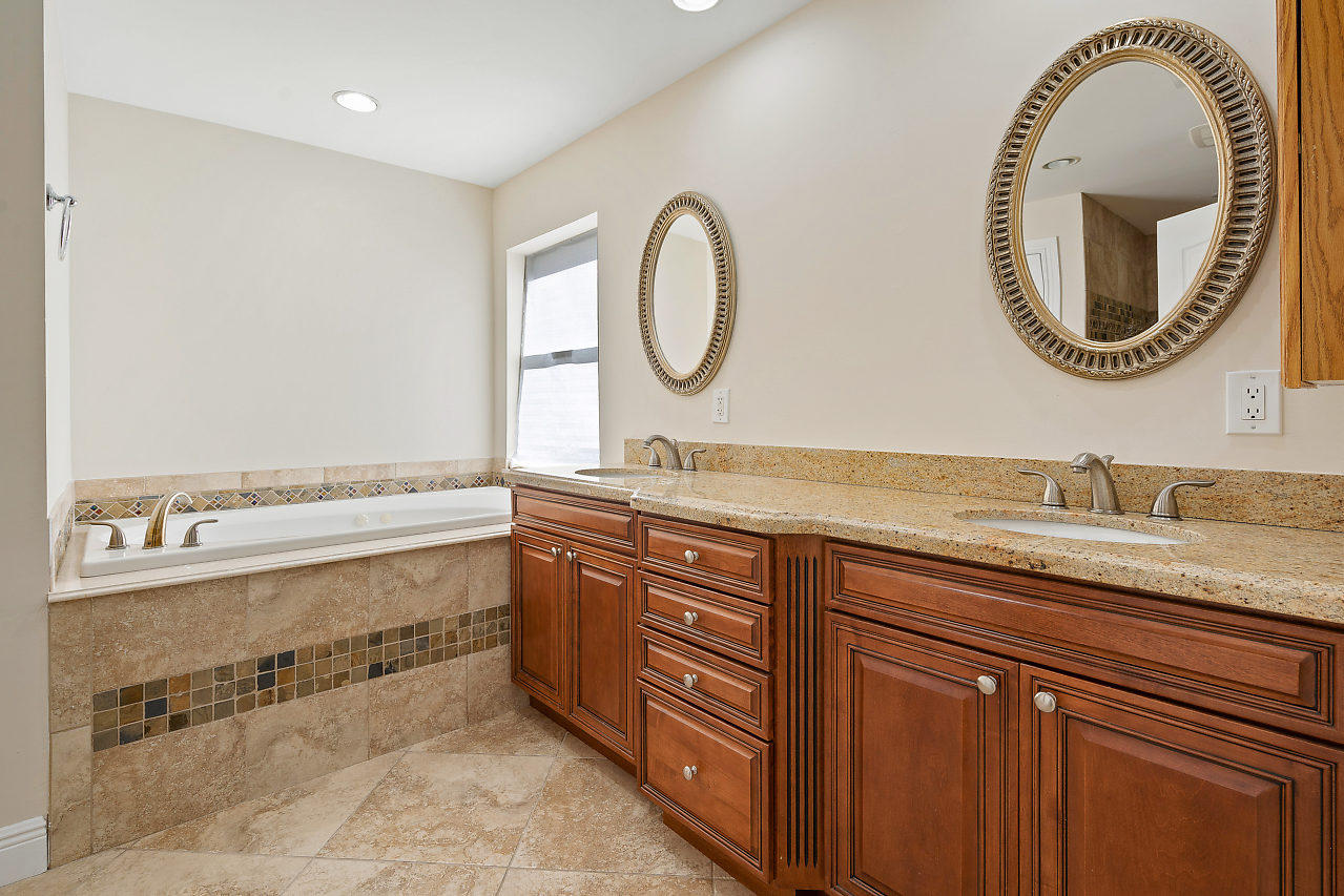 4572 White Cedar Lane Delray Beach, FL 33445 - Photo 17 of 37 a bathroom with a granite countertop double vanity and a mirror