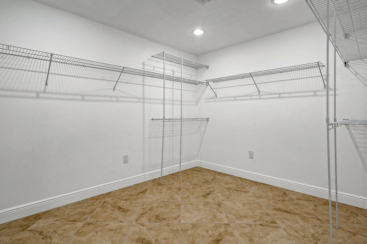4572 White Cedar Lane Delray Beach, FL 33445 - Photo 19 of 37 a view of a room with racks on the wall