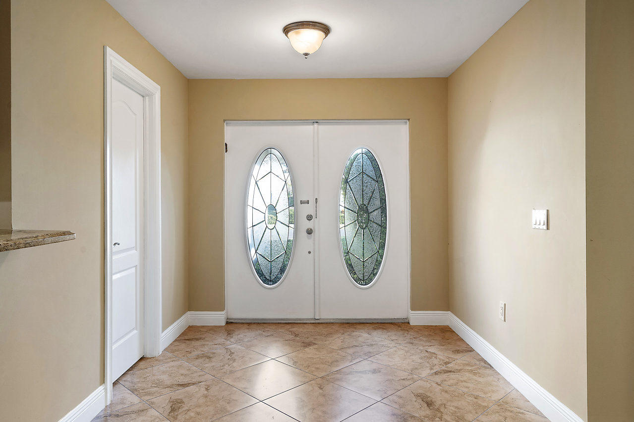 4572 White Cedar Lane Delray Beach, FL 33445 - Photo 3 of 37 a view of a hallway with painted walls