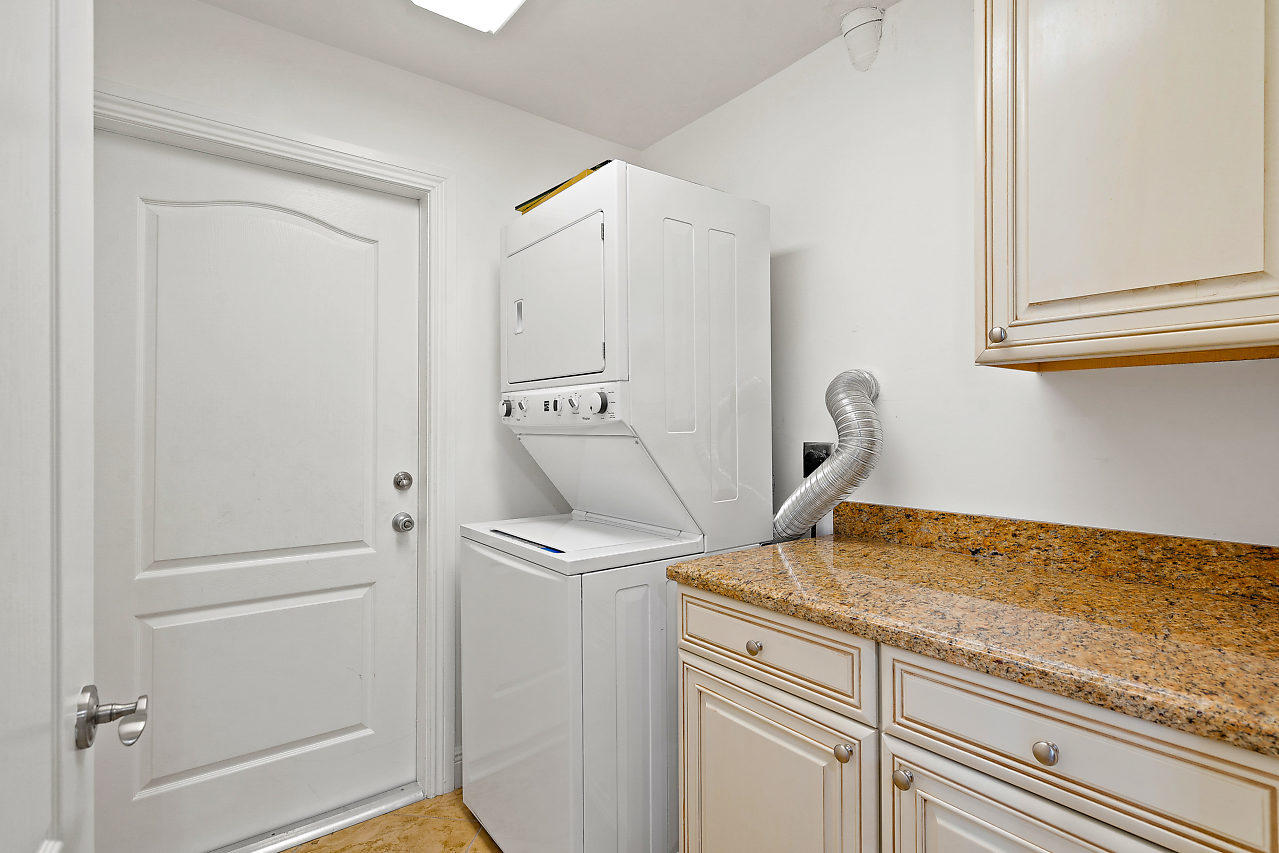 4572 White Cedar Lane Delray Beach, FL 33445 - Photo 24 of 37 a view of a storage and utility room with washer dryer