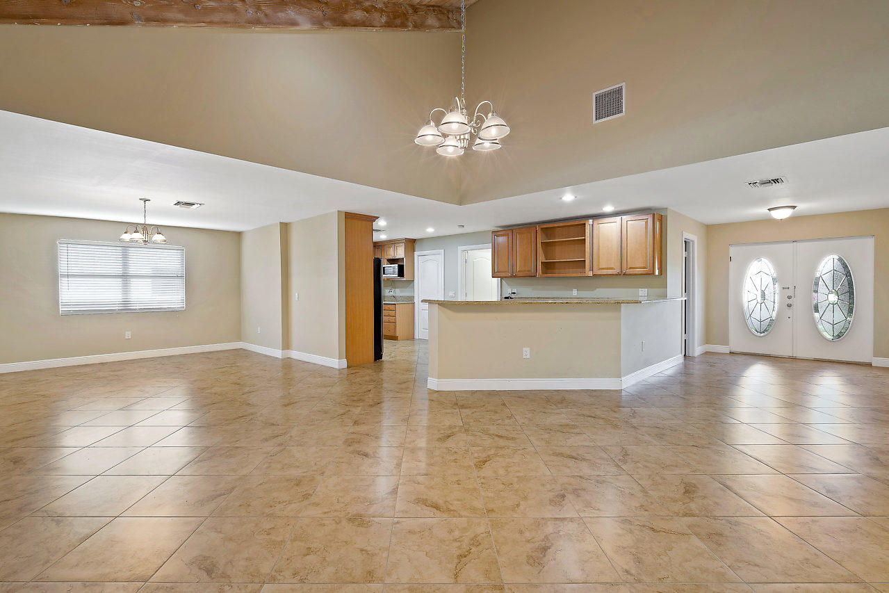 4572 White Cedar Lane Delray Beach, FL 33445 - Photo 4 of 37 a view of a kitchen with a stove cabinets and a chandelier
