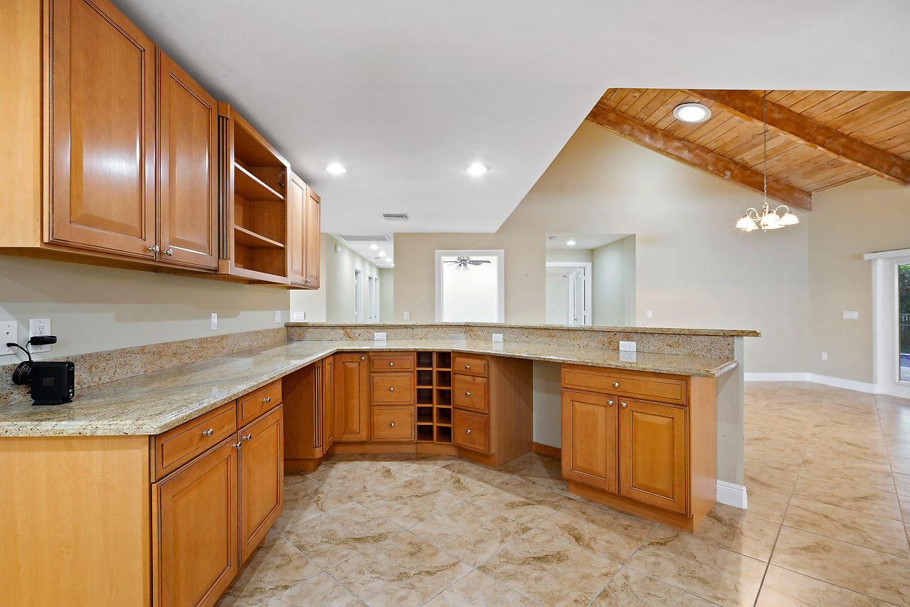 4572 White Cedar Lane Delray Beach, FL 33445 - Photo 6 of 37 a large kitchen with stainless steel appliances granite countertop a sink and cabinets