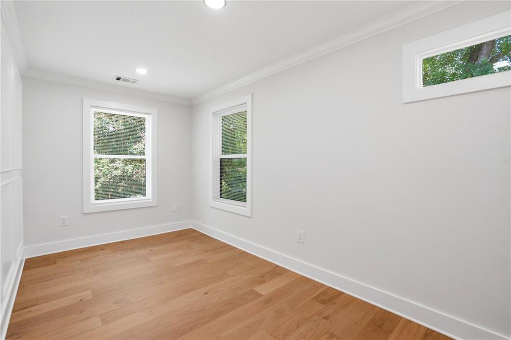 134 Henry Meyer Road Winterville, GA 30683 - Photo 25 of 34 an empty room with wooden floor and windows