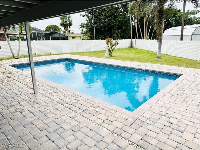 a view of a swimming pool with an outdoor seating