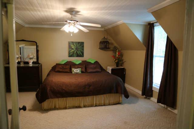 25 Sykes Road Hickman, TN 38567 - Photo 8 of 20 Bedroom 3 is also upstairs and includes a ceiling fan.