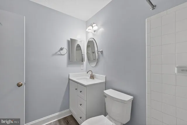 a bathroom with a toilet sink and mirror