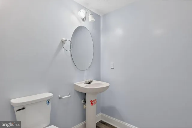 a bathroom with a sink mirror toilet and a mirror