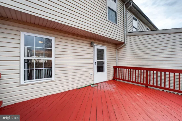 a view of a house with wooden deck