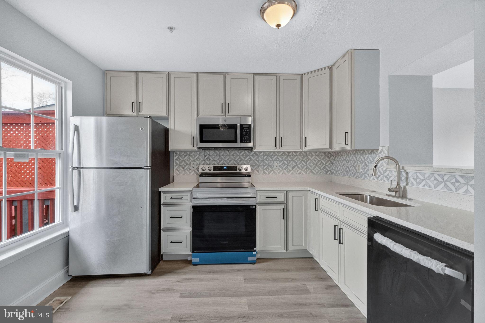 2116 Amber Way Baltimore, MD 21244 - Photo 2 of 22 a kitchen with a refrigerator stove and sink