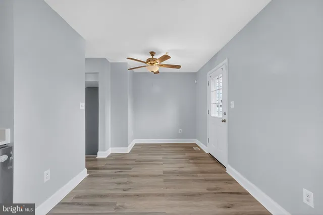 a view of an empty room with wooden floor