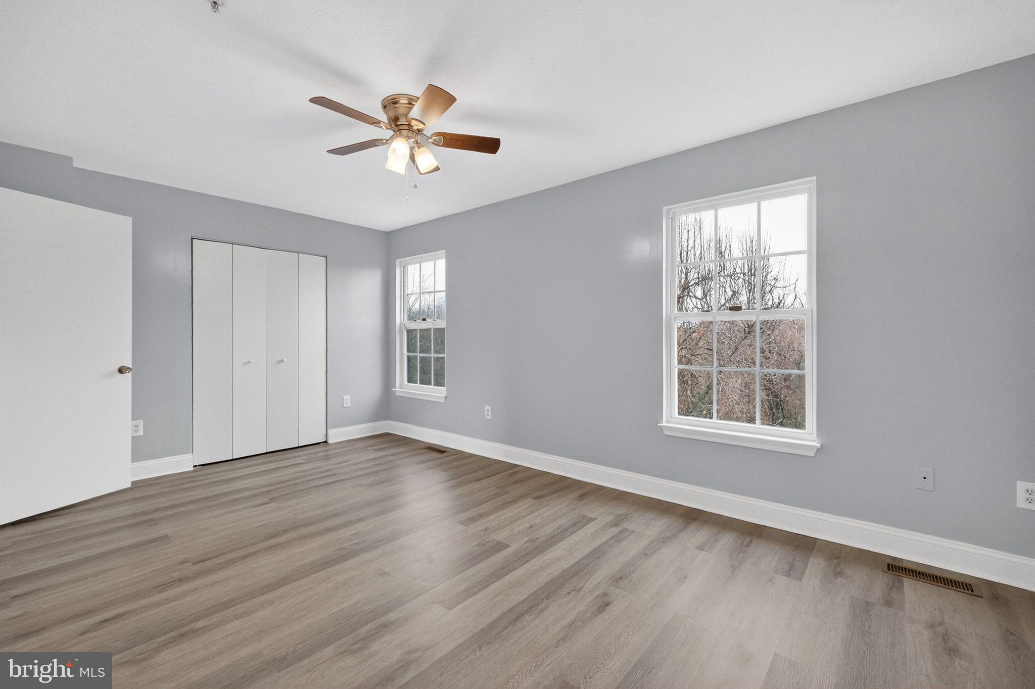 2116 Amber Way Baltimore, MD 21244 - Photo 8 of 22 a view of an empty room with wooden floor and a window