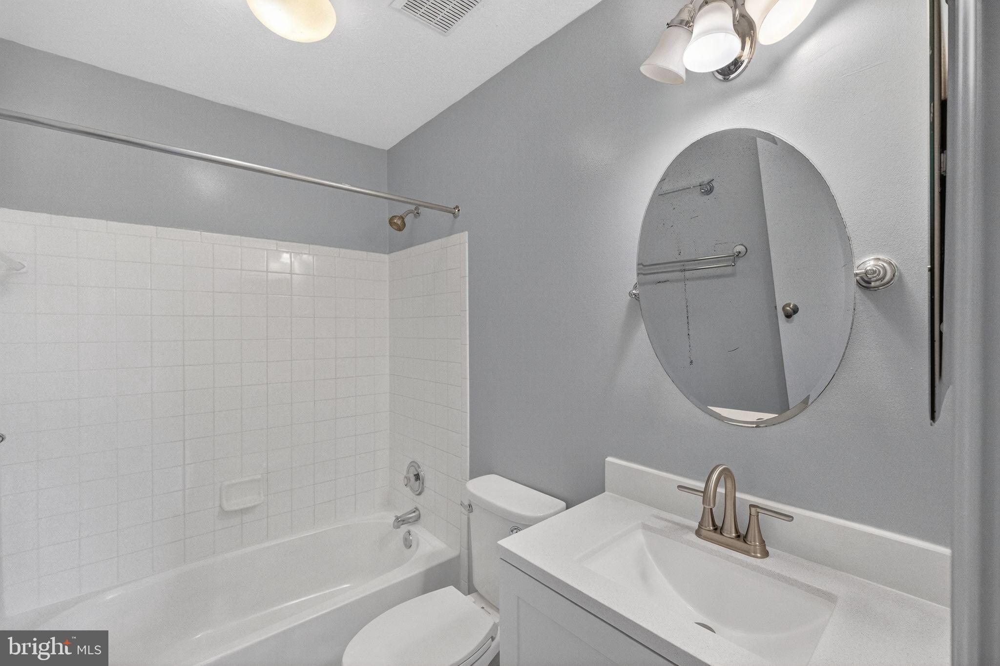 2116 Amber Way Baltimore, MD 21244 - Photo 9 of 22 a bathroom with a sink toilet and a mirror