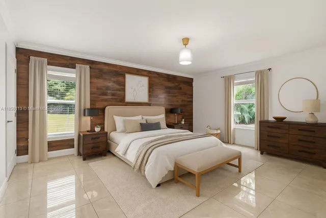 a bedroom with a bed mirror and window