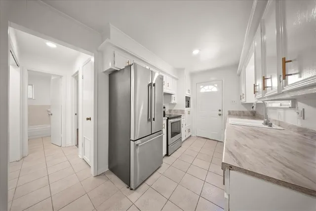 a kitchen with granite countertop a refrigerator and a sink