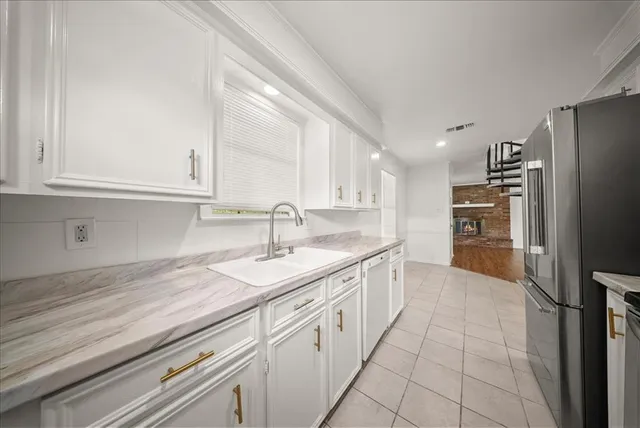 a kitchen with a sink and refrigerator
