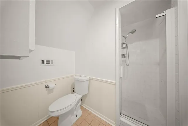 a white toilet sitting next to a bathroom sink
