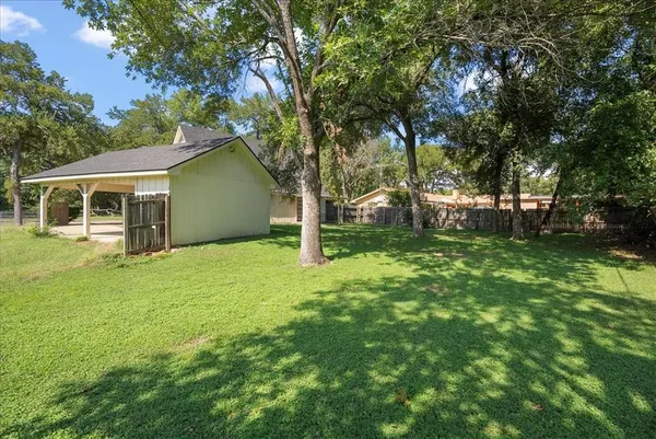 a view of a house with backyard and tree
