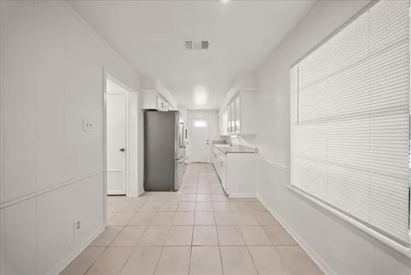 a view of a storage & utility room with a sink