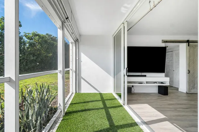 a view of living room with furniture and a flat screen tv