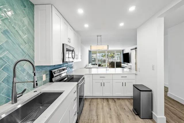 a kitchen with sink cabinets and stove