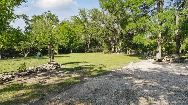 an aerial view of a house with a yard and trees