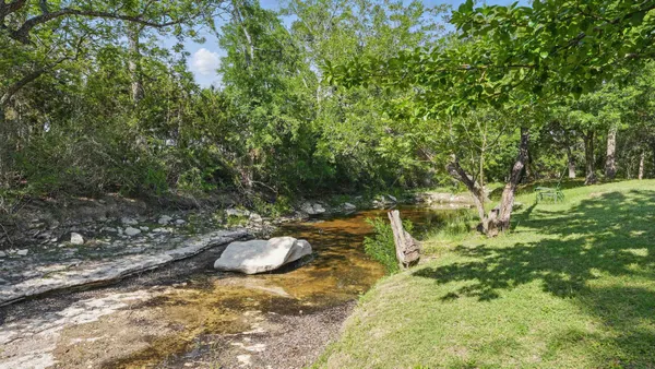 a view of backyard with swimming pool and sitting area